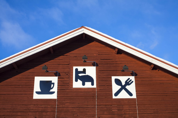 hotel-signs-on-a-red-building-shutterstock_107243447-2-585x390